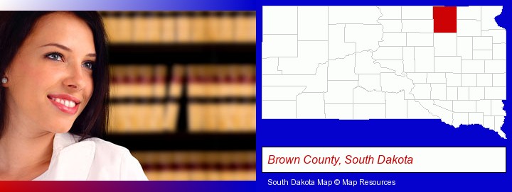 a young, female attorney in a law library; Brown County, South Dakota highlighted in red on a map