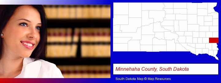 a young, female attorney in a law library; Minnehaha County, South Dakota highlighted in red on a map