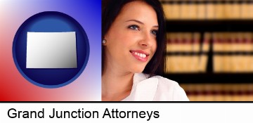 a young, female attorney in a law library in Grand Junction, CO