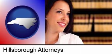 a young, female attorney in a law library in Hillsborough, NC