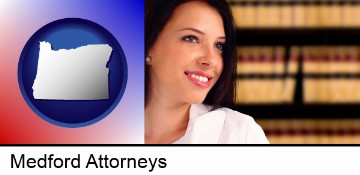 a young, female attorney in a law library in Medford, OR