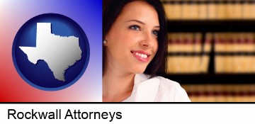 a young, female attorney in a law library in Rockwall, TX